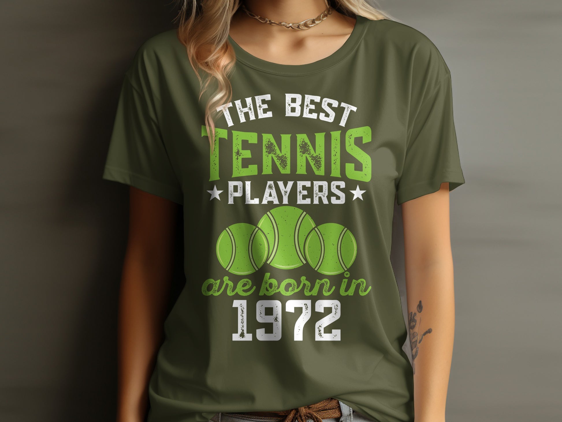 Green t-shirt with "The Best Tennis Players Are Born in 1972" text and tennis balls.