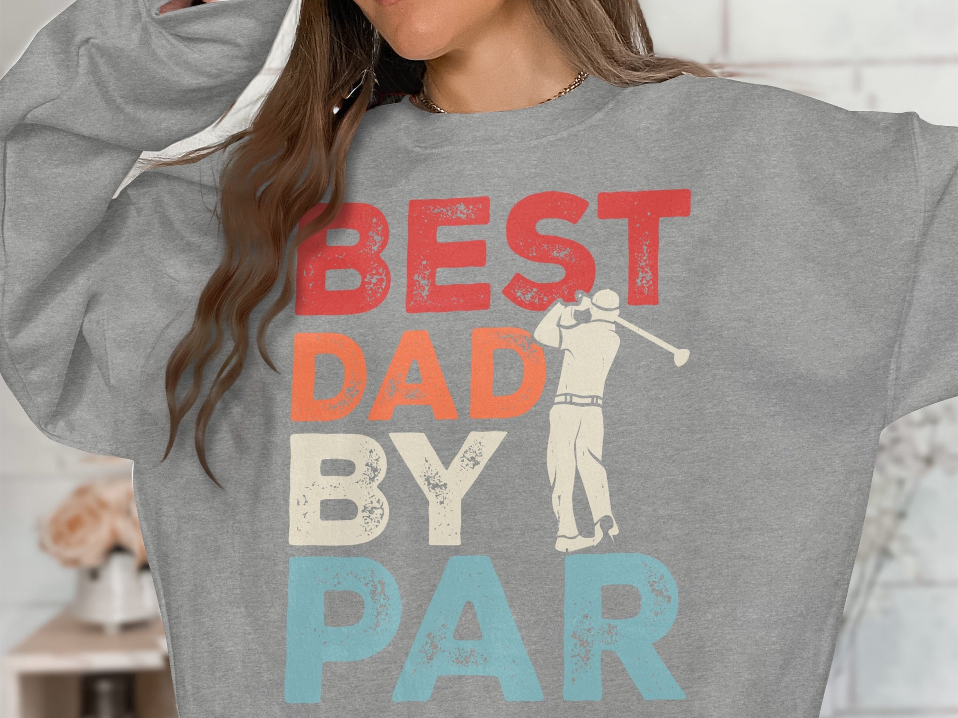 Grey sweatshirt with "BEST DAD BY PAR" text and golfer graphic.