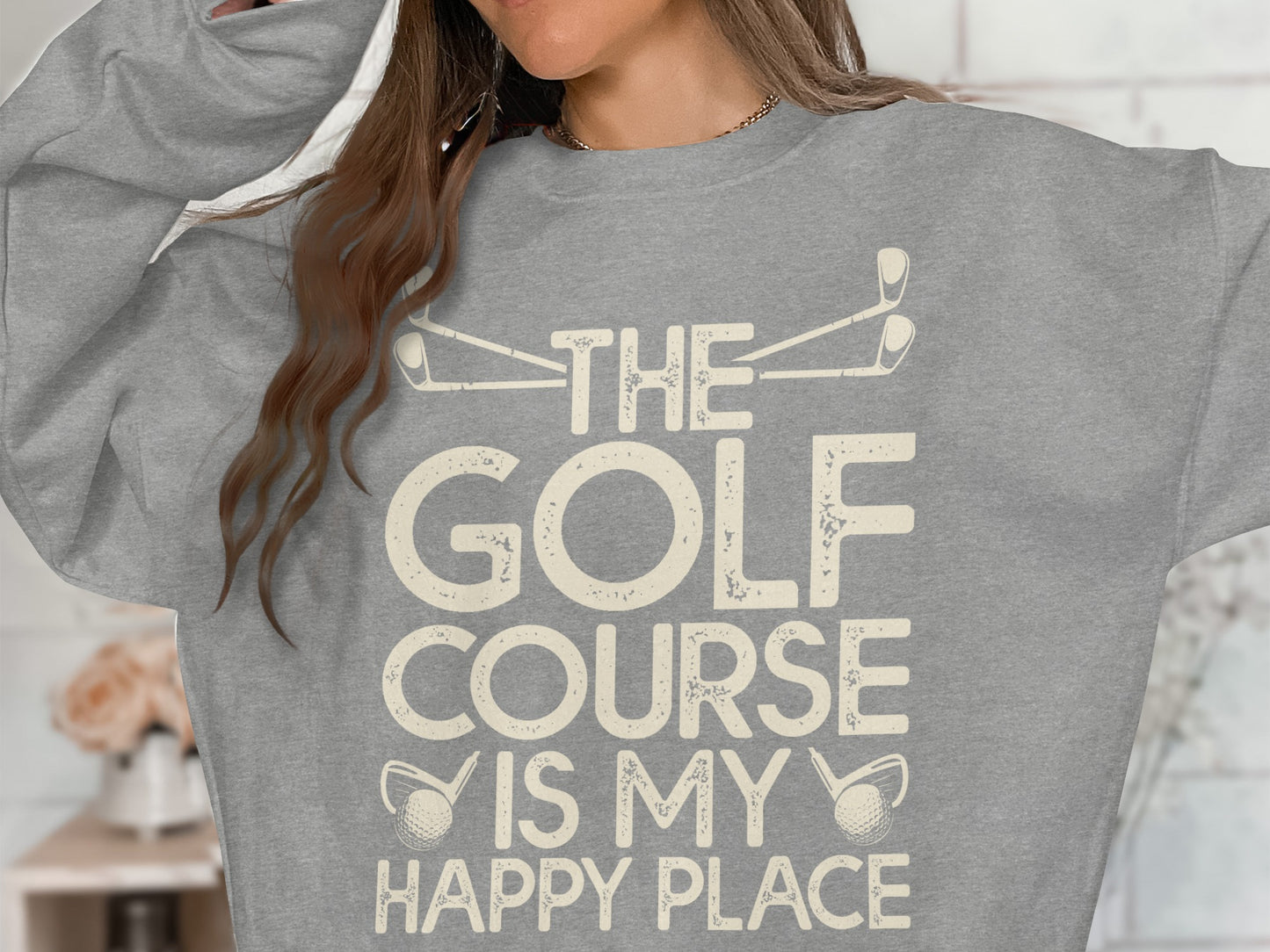 Gray sweatshirt with "The Golf Course is My Happy Place" text and golf club graphics.