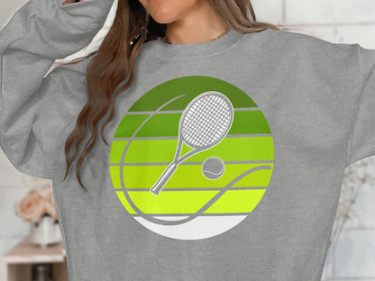 Gray sweatshirt featuring a circular tennis graphic with racket and ball.