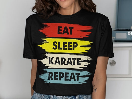 Black t-shirt with "Eat Sleep Karate Repeat" in red, yellow, blue, and white.