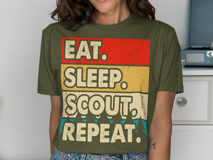 Green t-shirt with "Eat. Sleep. Scout. Repeat." text in bold yellow and red stripes.