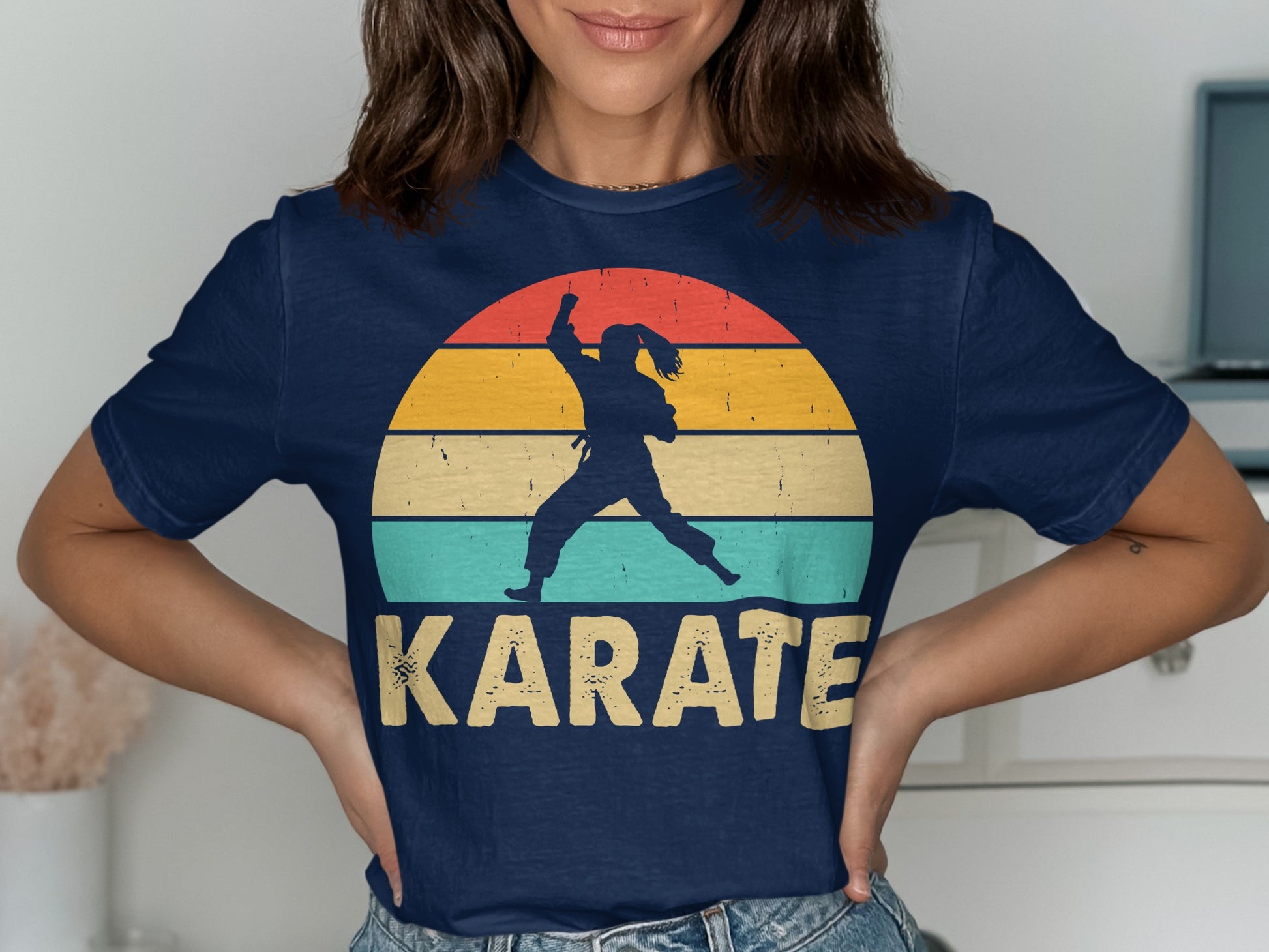 Navy t-shirt with a silhouette of a karate practitioner against a colorful sunset graphic.