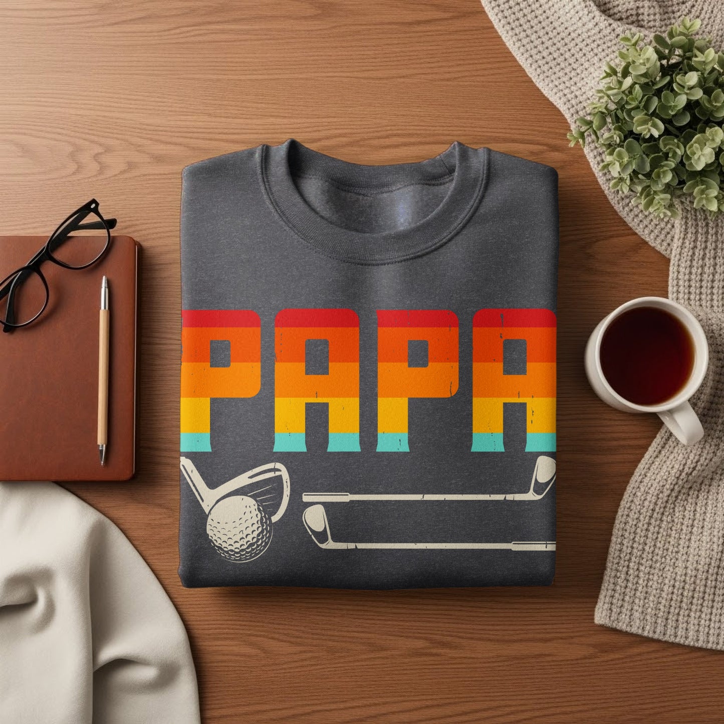 Dark gray sweatshirt with "PAPA" in rainbow stripes and golf club graphics.