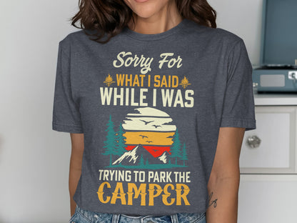 Dark grey t-shirt with "Sorry For What I Said While Trying To Park The Camper" text and sunset graphic.