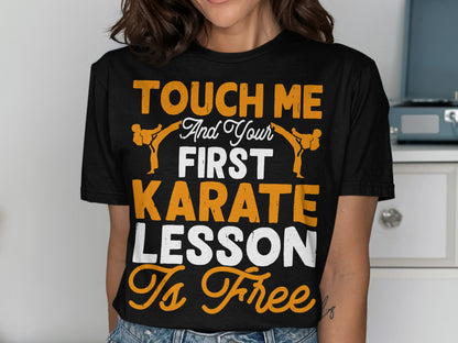 Black t-shirt with orange and white text "Touch me and your first karate lesson is free".