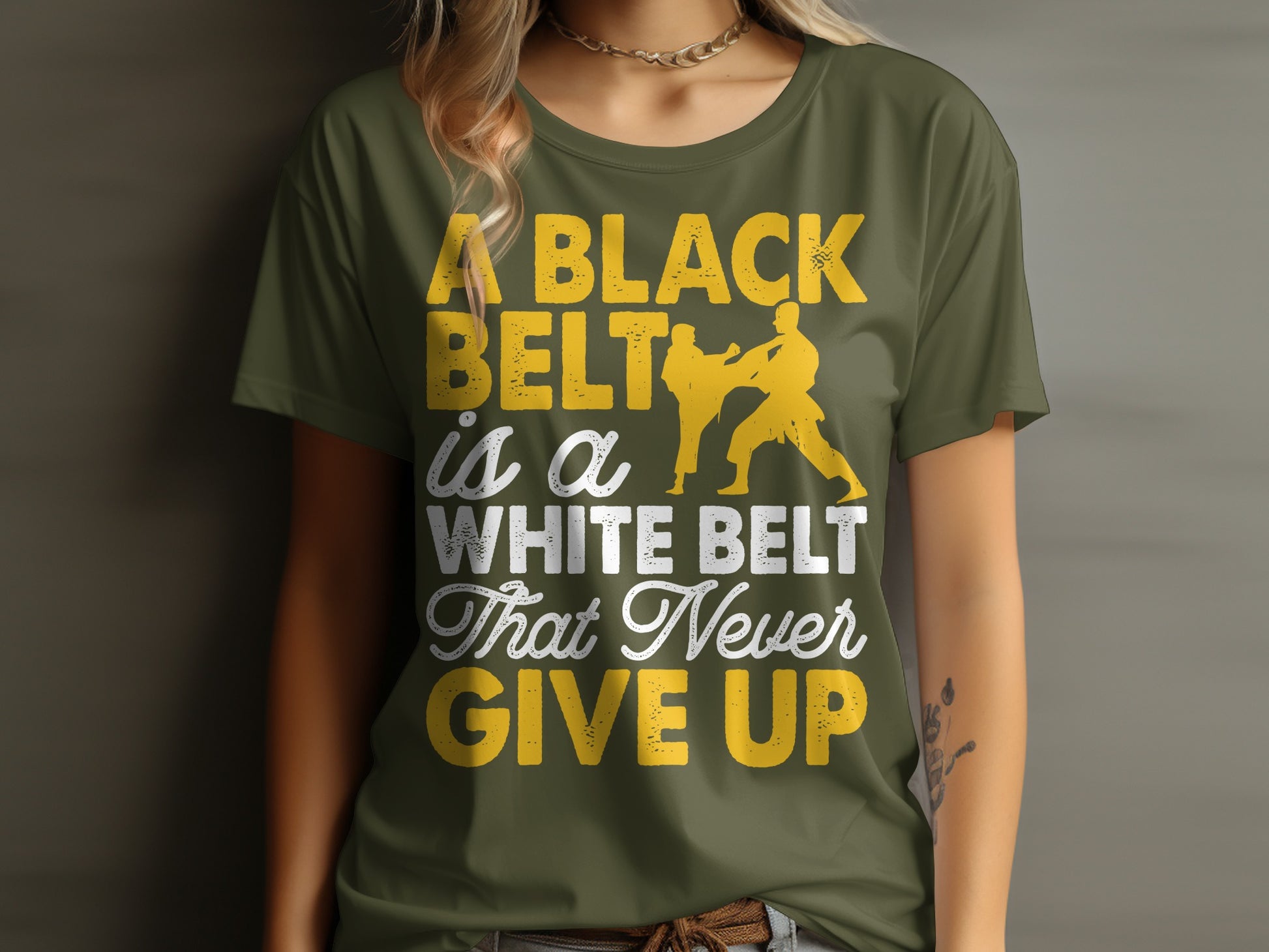 Green t-shirt with yellow text: "A black belt is a white belt that never give up".