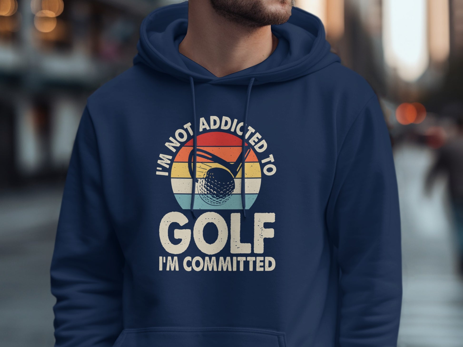 Navy hoodie with "I'm Not Addicted to Golf, I'm Committed" text and golf ball graphic.