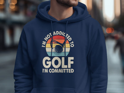 Navy hoodie with "I'm Not Addicted to Golf, I'm Committed" text and golf ball graphic.