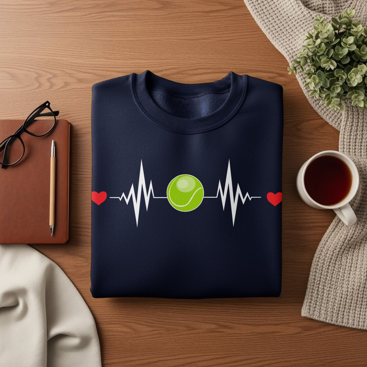 Navy sweatshirt with a green tennis ball on a heartbeat line.