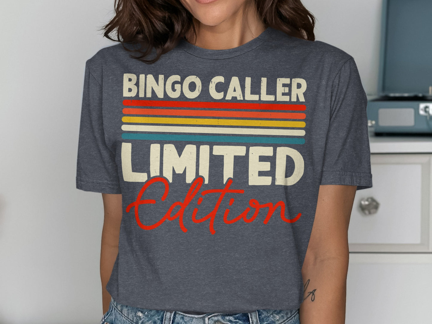 Dark grey t-shirt with "BINGO CALLER LIMITED EDITION" text in colorful stripes.