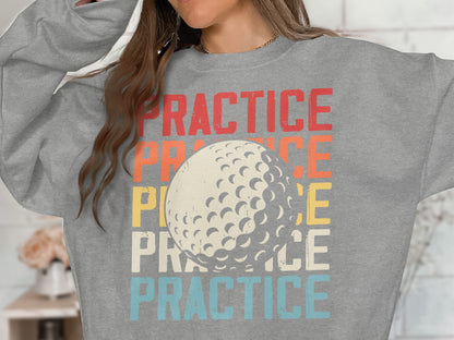 Woman wearing gray sweatshirt with "PRACTICE" text and golf ball graphic.