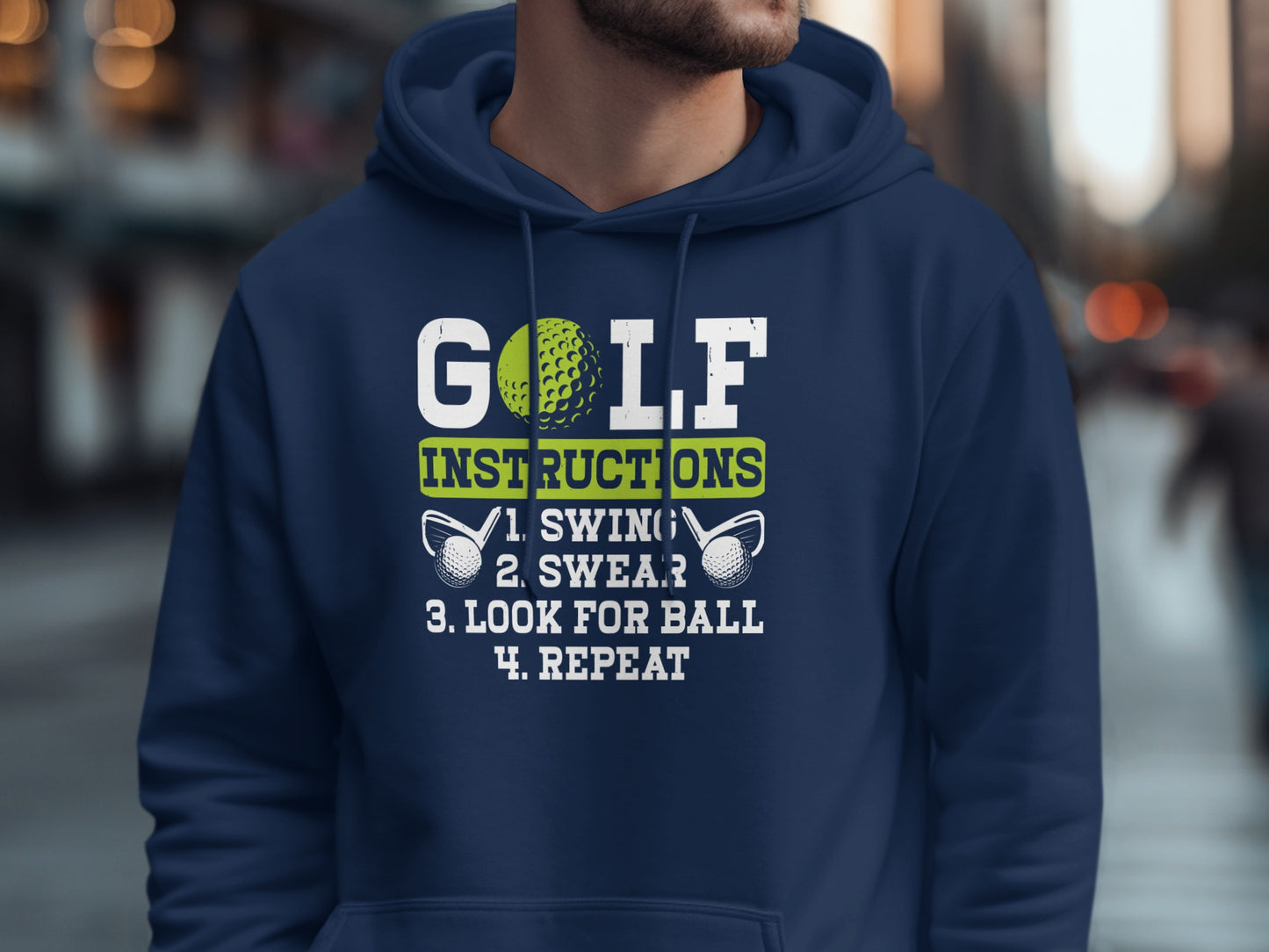 Navy hoodie with white text: "GOLF INSTRUCTIONS: 1. SWING. 2. SWEAR. 3. LOOK FOR BALL. 4. REPEAT."