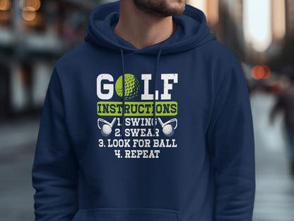 Navy hoodie with white text: "GOLF INSTRUCTIONS: 1. SWING. 2. SWEAR. 3. LOOK FOR BALL. 4. REPEAT."