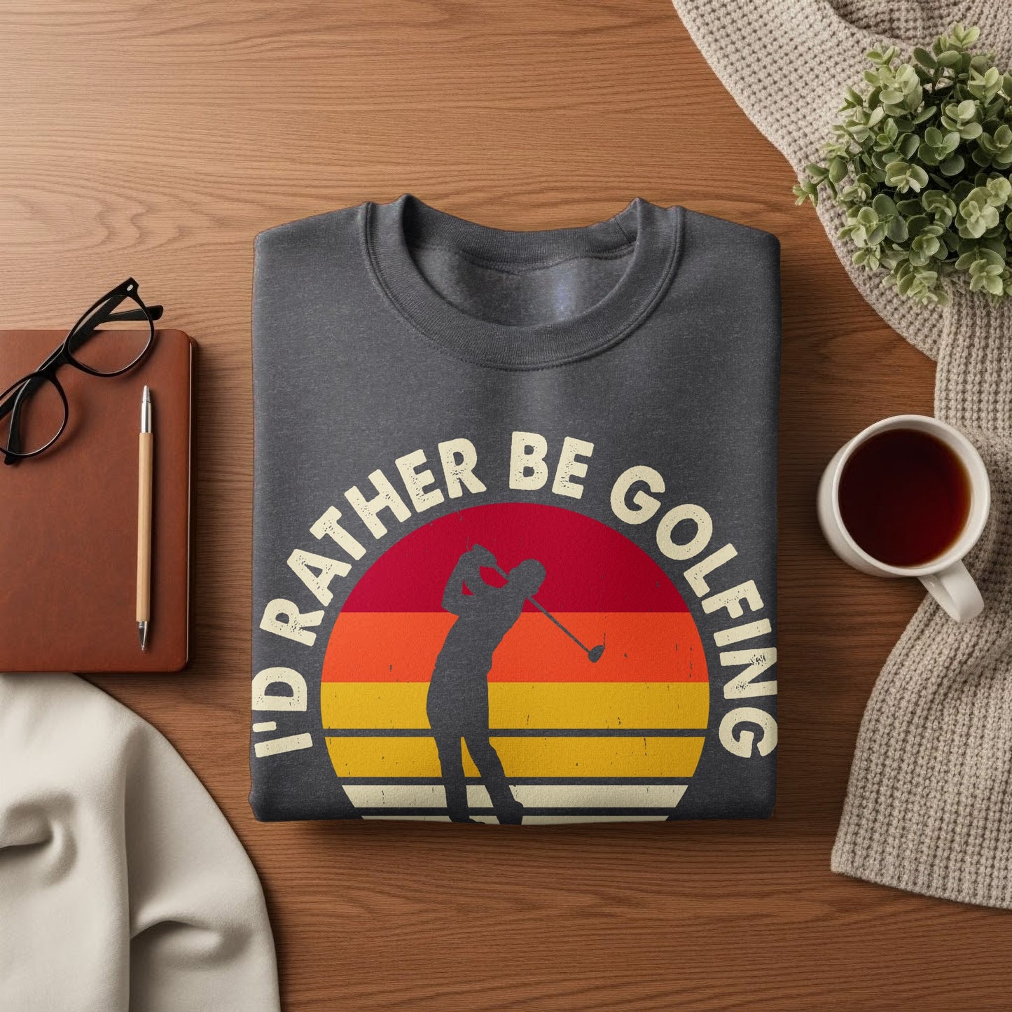 Dark gray sweatshirt with "I'd Rather Be Golfing" text and golf silhouette design.