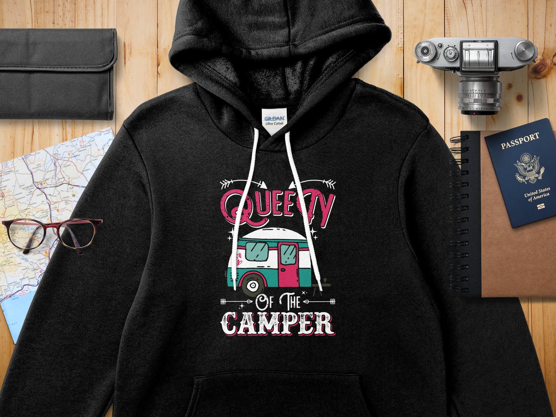 Black hooded sweatshirt with "Quee of the Camper" graphic and vintage camper illustration.