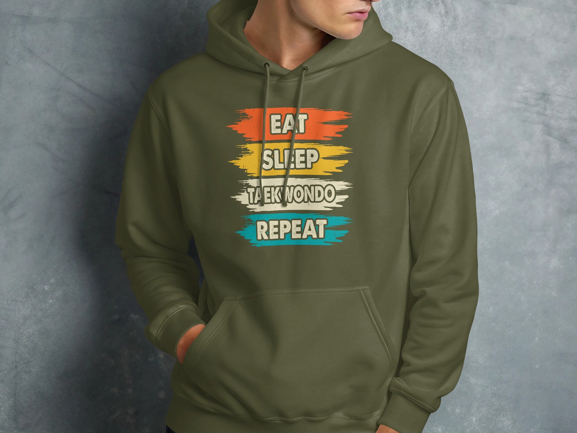 Green hoodie with "Eat Sleep Taekwondo Repeat" text in colorful stripes.
