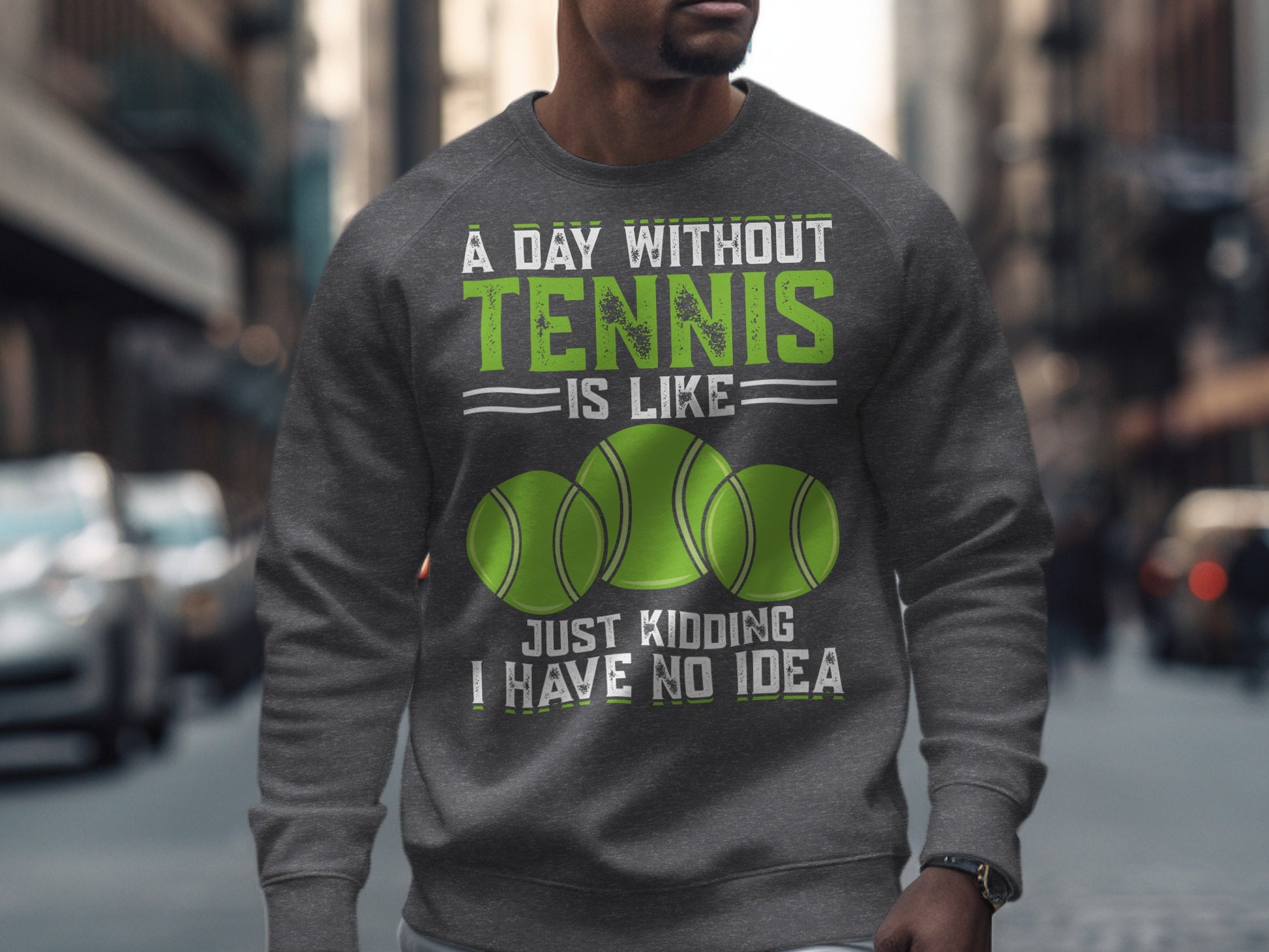 Grey sweatshirt with "A Day Without Tennis is Like... Just Kidding I Have No Idea" text and tennis balls.