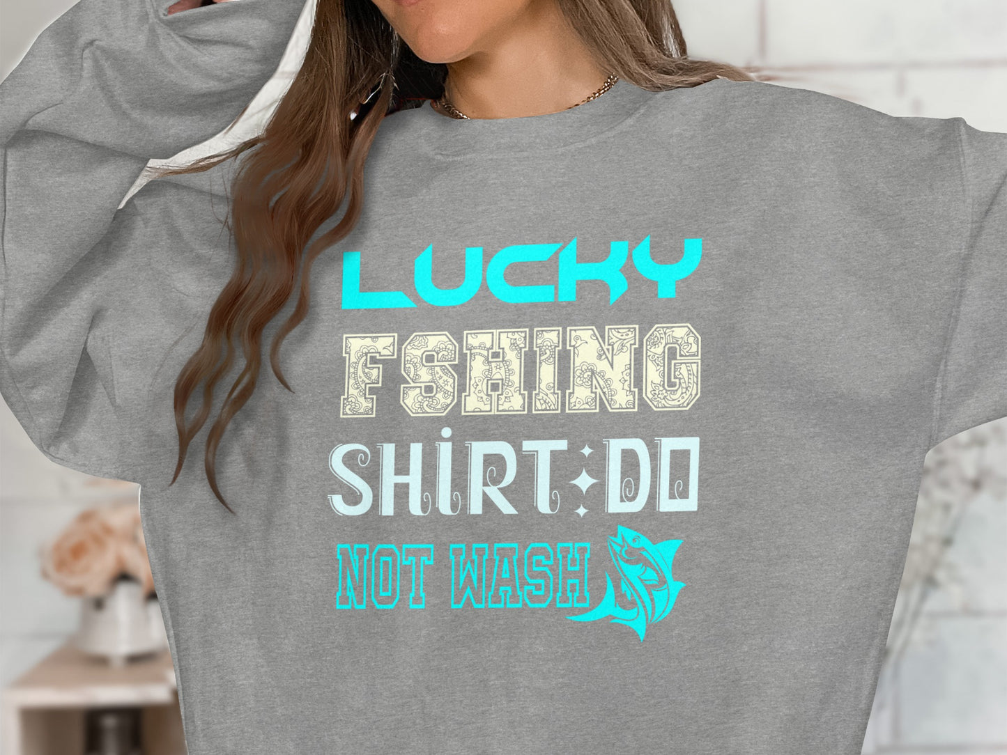 Grey sweatshirt with "Lucky Fishing Shirt: Do Not Wash" text and fish graphic.