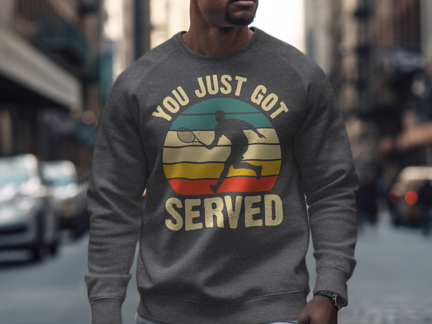 Dark grey sweatshirt with a circular graphic of a tennis player and text "YOU JUST GOT SERVED".