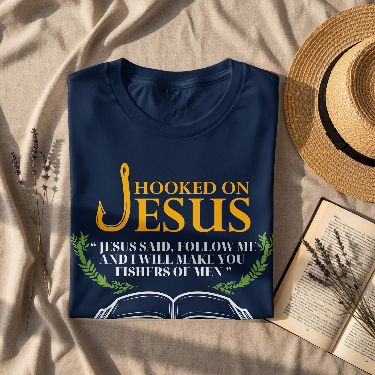 Navy t-shirt with "Hooked on Jesus" and biblical quote, open book graphic.