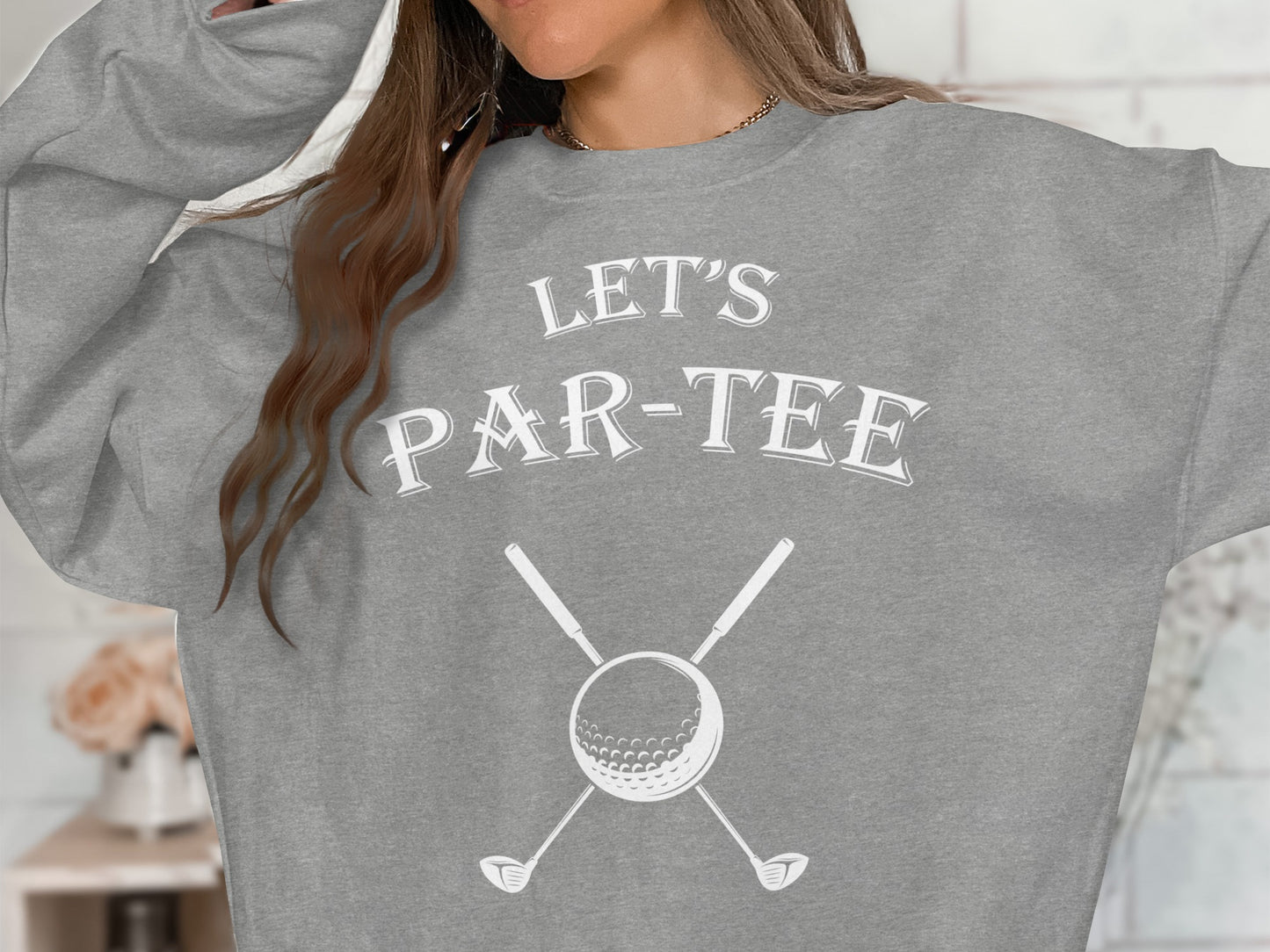 Grey sweatshirt with "LET'S PAR-TEE" and golf ball with clubs.