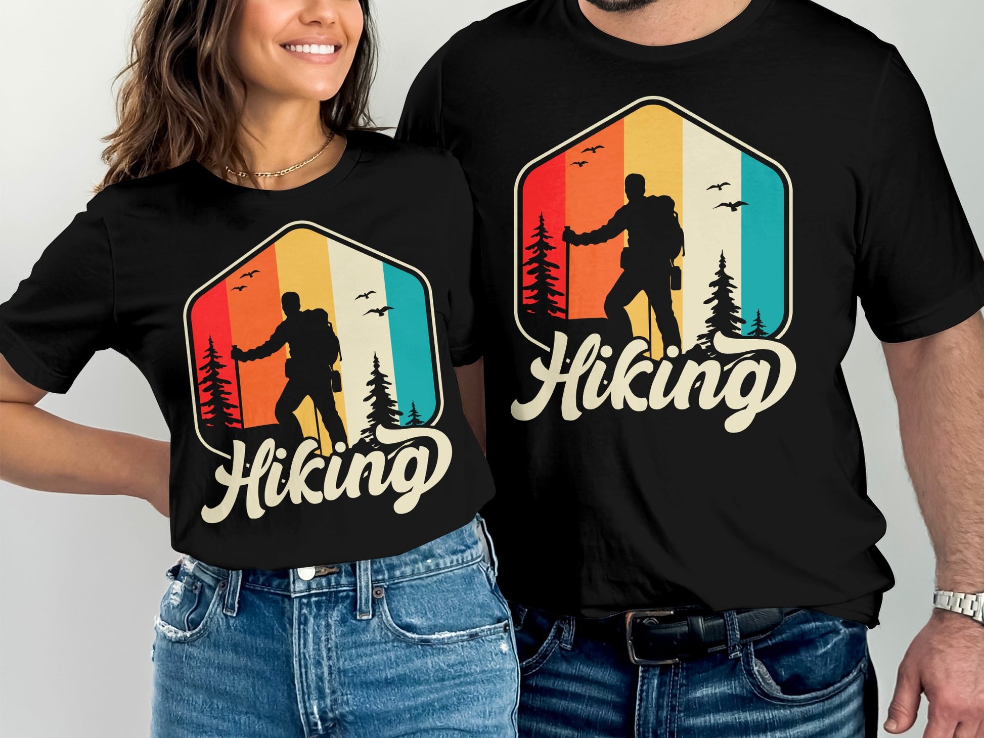 Couple wearing matching black t-shirts with a retro hiking graphic.