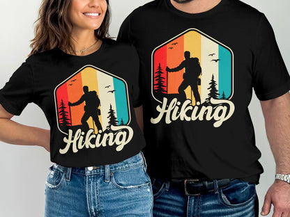 Couple wearing matching black t-shirts with a retro hiking graphic.