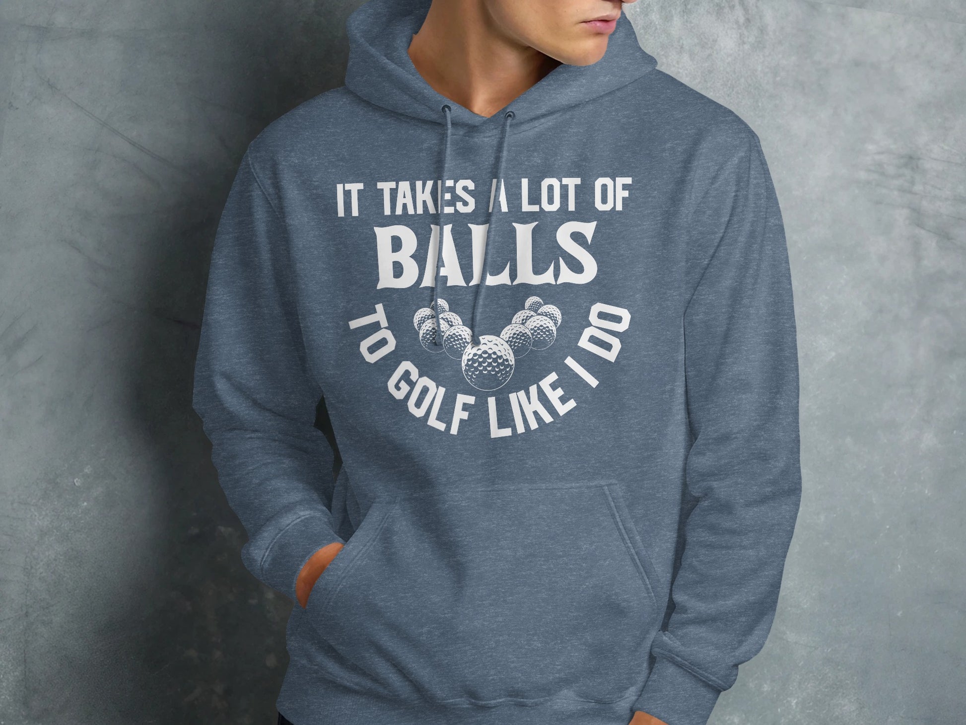 Blue hoodie with "It takes a lot of balls to golf like I do" text and golf balls.