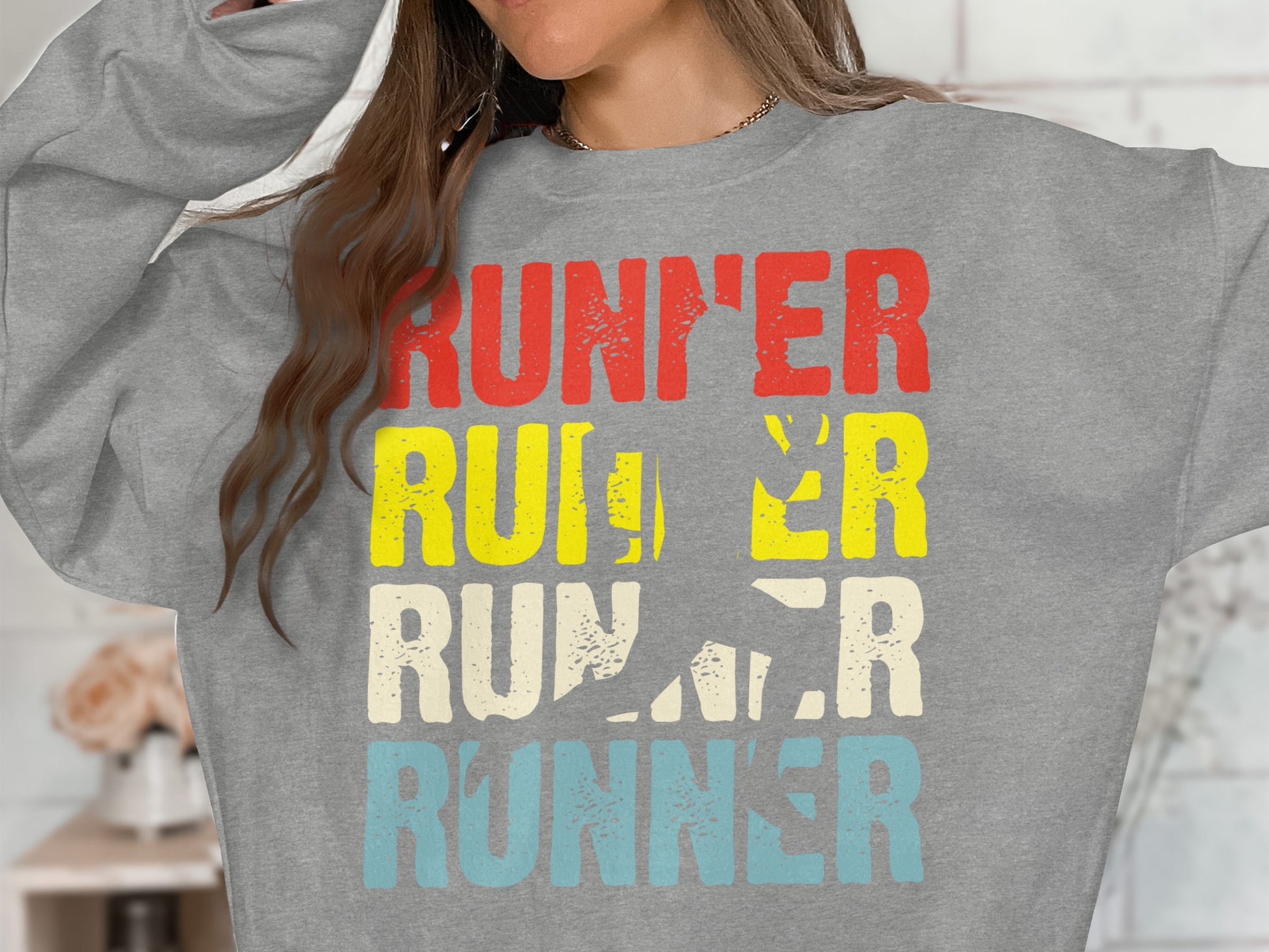 Runner graphic sweatshirt with running silhouette on gray fabric.
