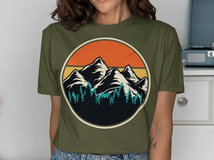 Olive green t-shirt with mountain and forest sunset graphic in a circle.