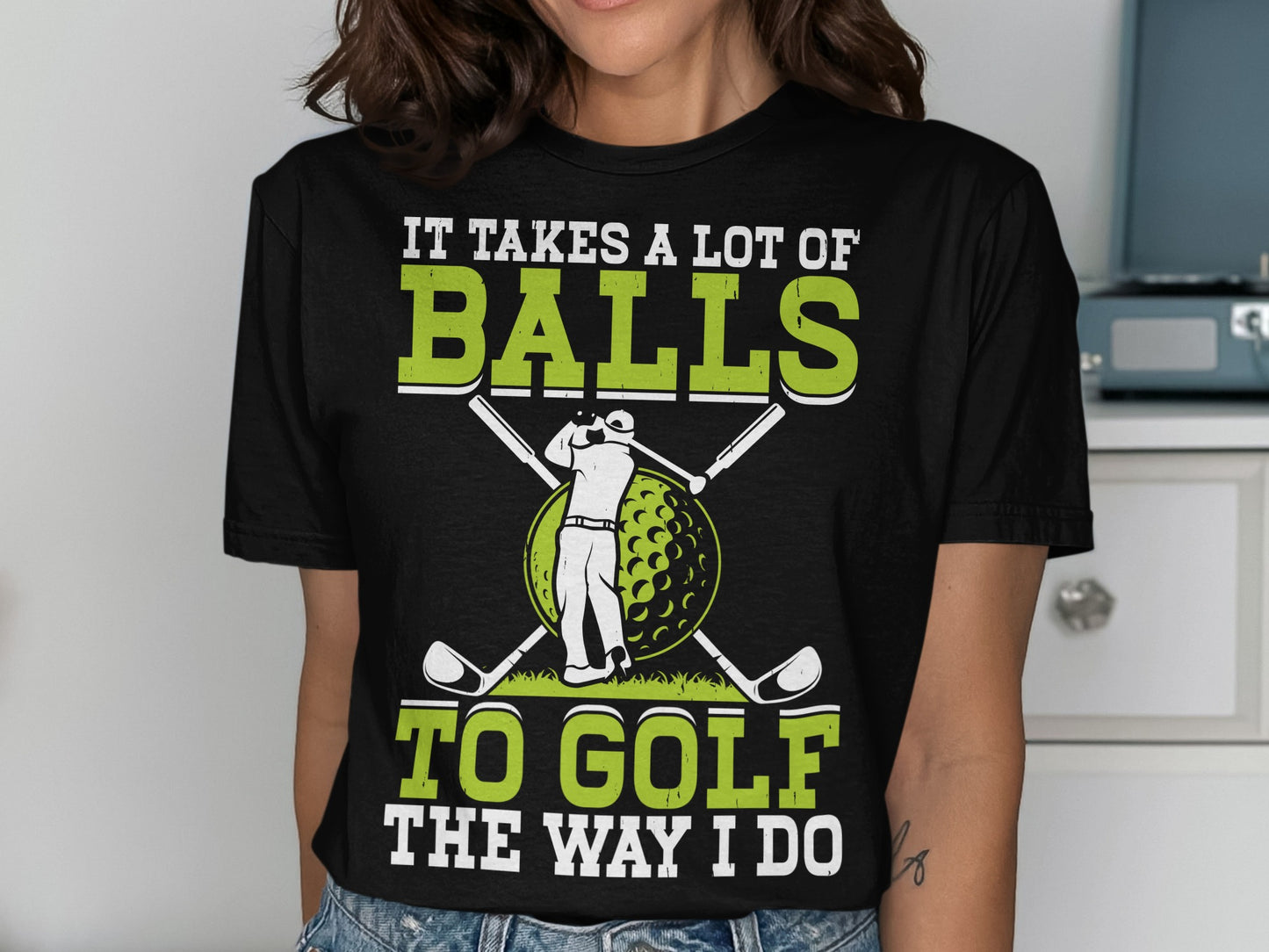 Black t-shirt with white and green text and golf graphic.