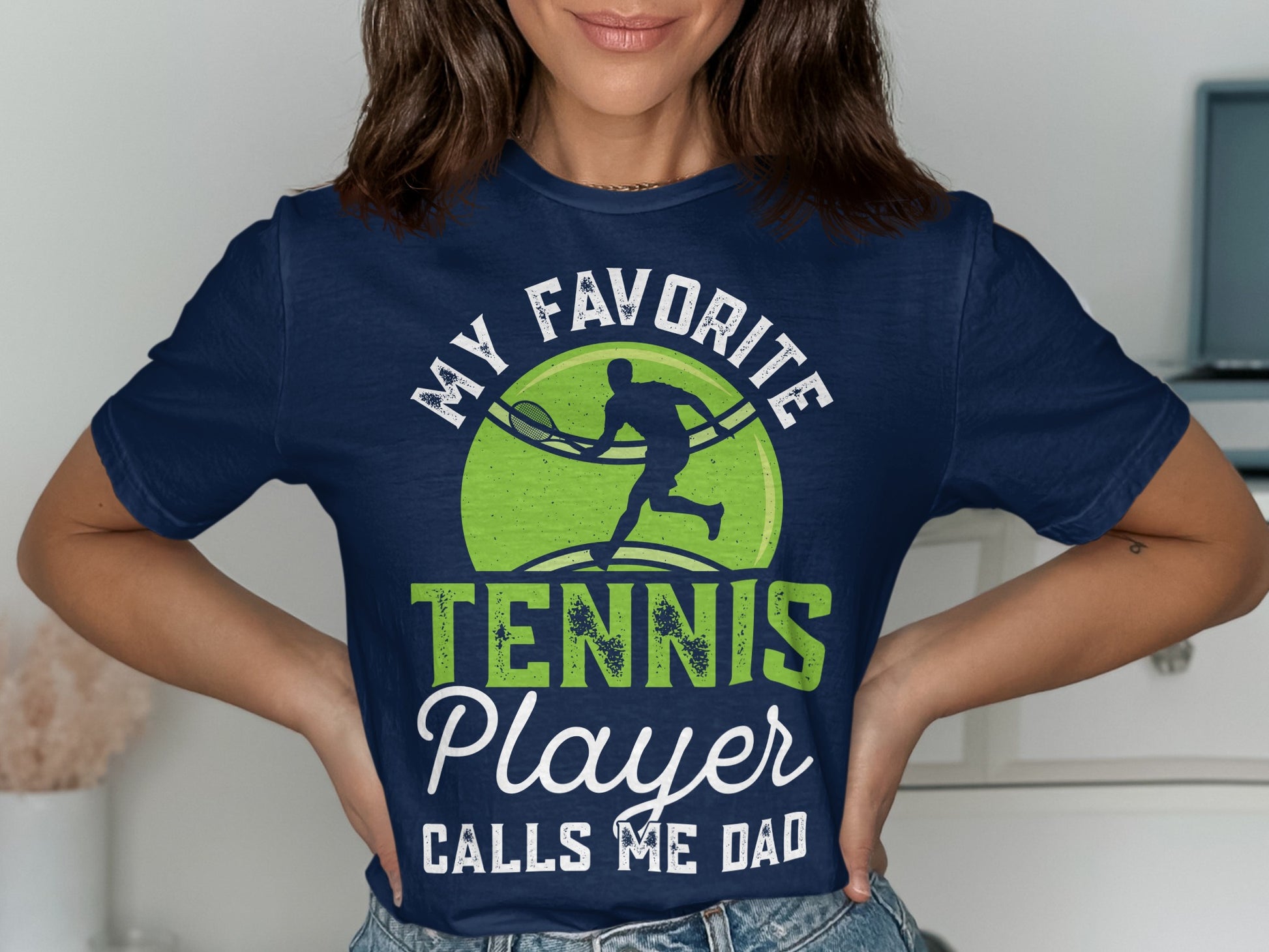 Navy t-shirt with "MY FAVORITE TENNIS PLAYER CALLS ME DAD" and tennis graphic.