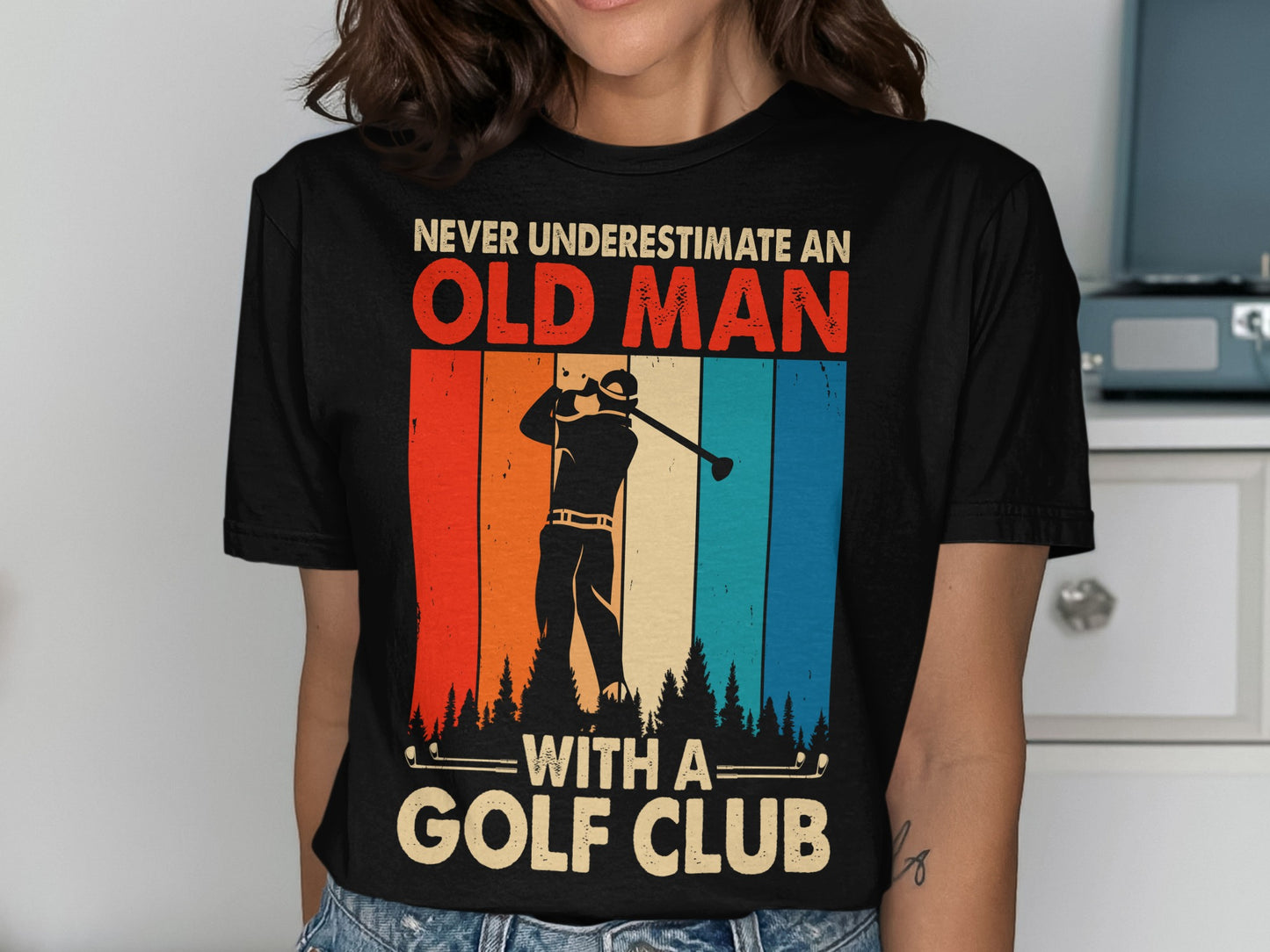 Black t-shirt with graphic of golfer and text "Never Underestimate An Old Man With A Golf Club".