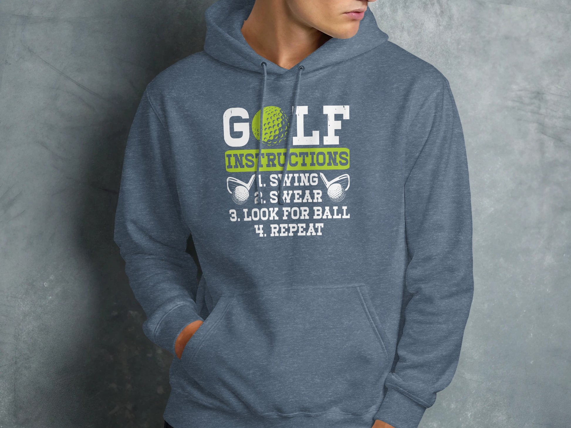 Grey hoodie with "GOLF INSTRUCTIONS: 1. SWING 2. S YEAR 3. LOOK FOR BALL 4. REPEAT" text.