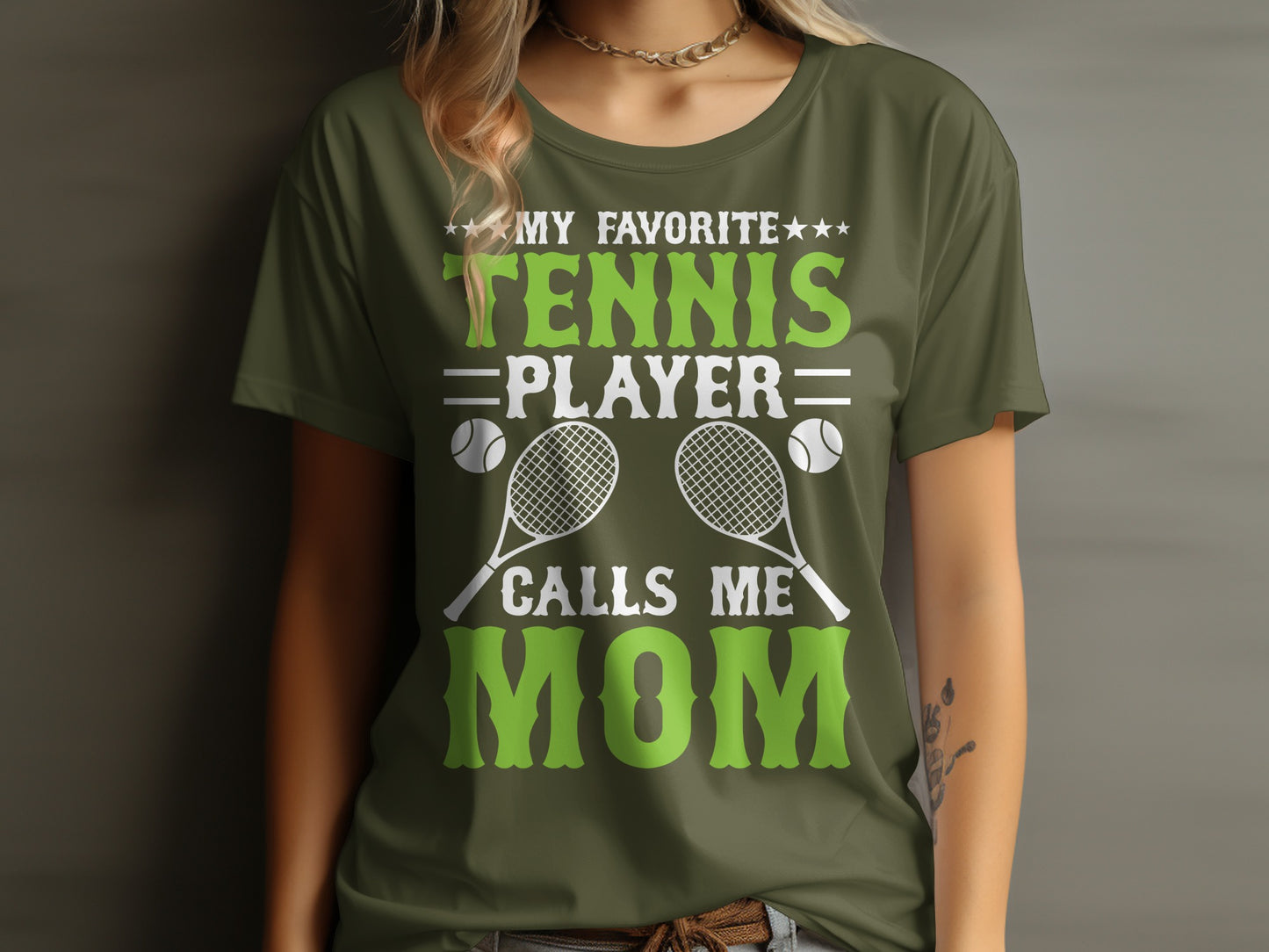 Green t-shirt with "My Favorite Tennis Player Calls Mom" text and tennis graphics.