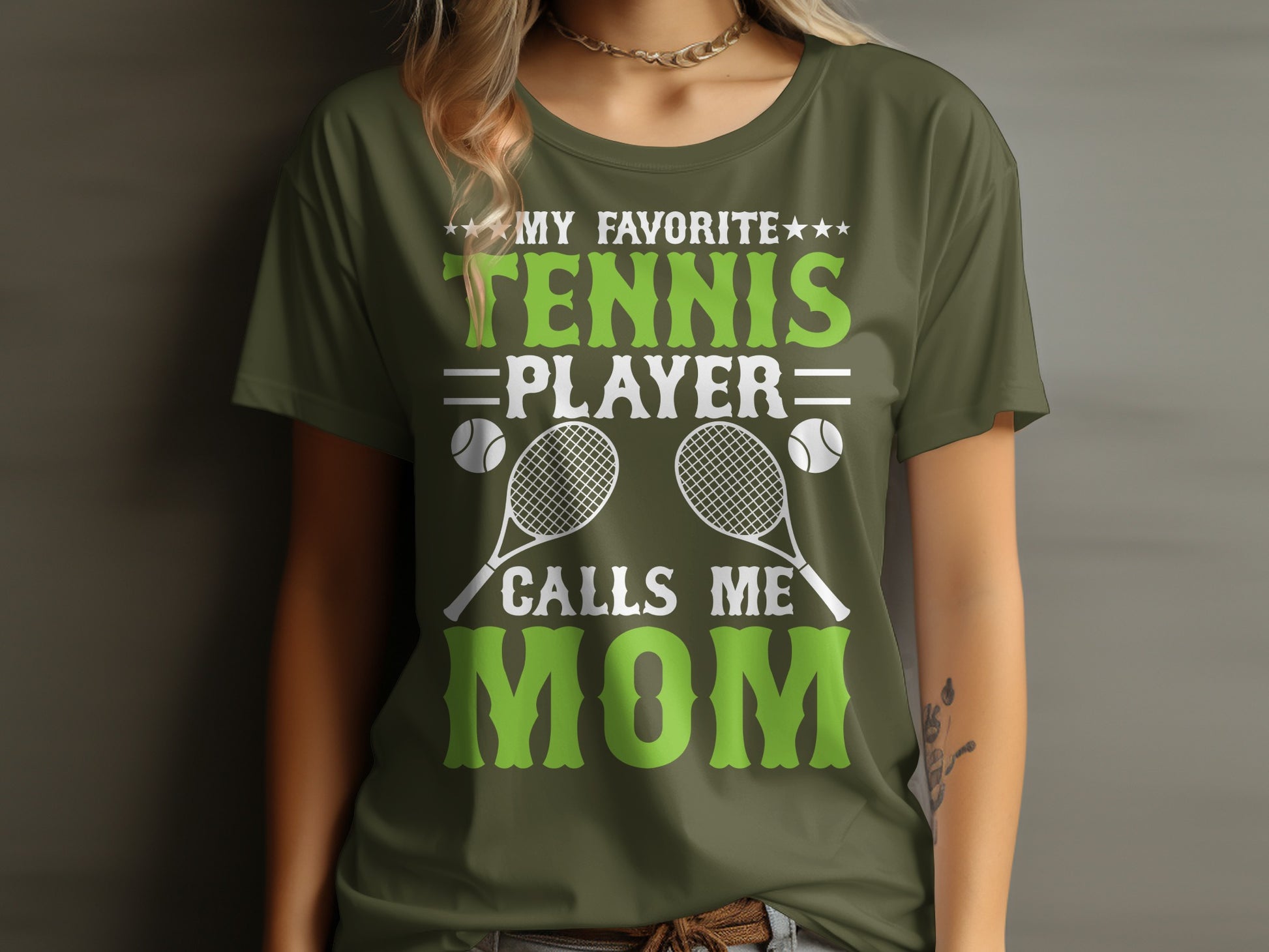 Green t-shirt with "My Favorite Tennis Player Calls Mom" text and tennis graphics.
