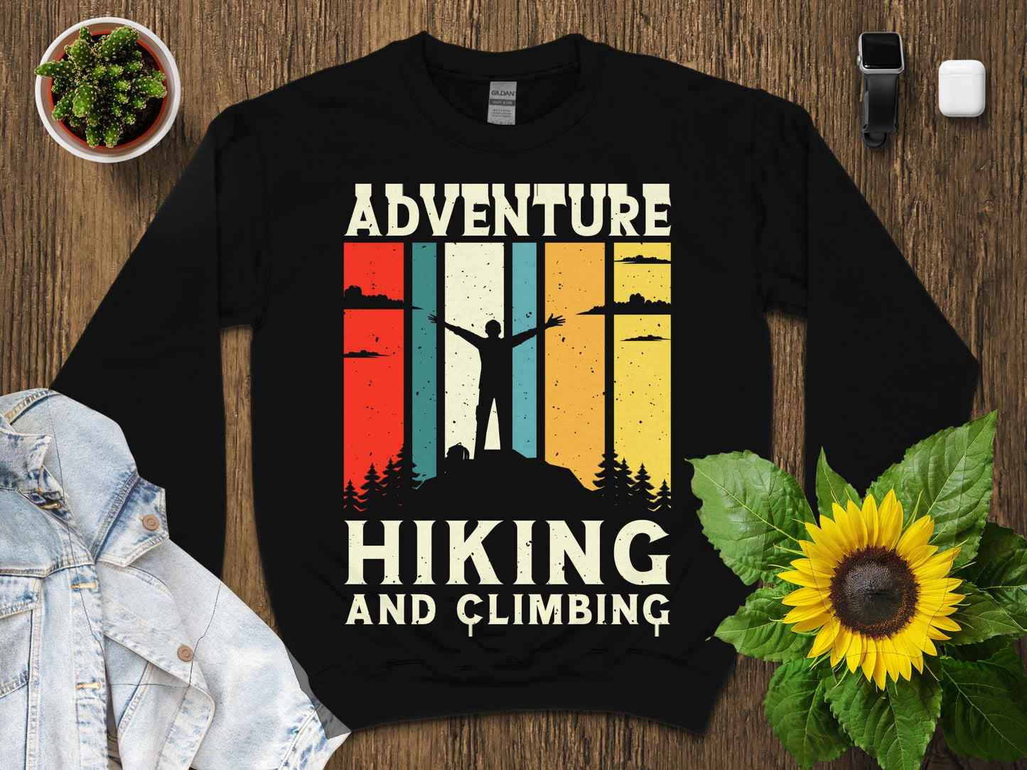 Black sweatshirt with "Adventure Hiking and Climbing" text and retro sunset graphic.