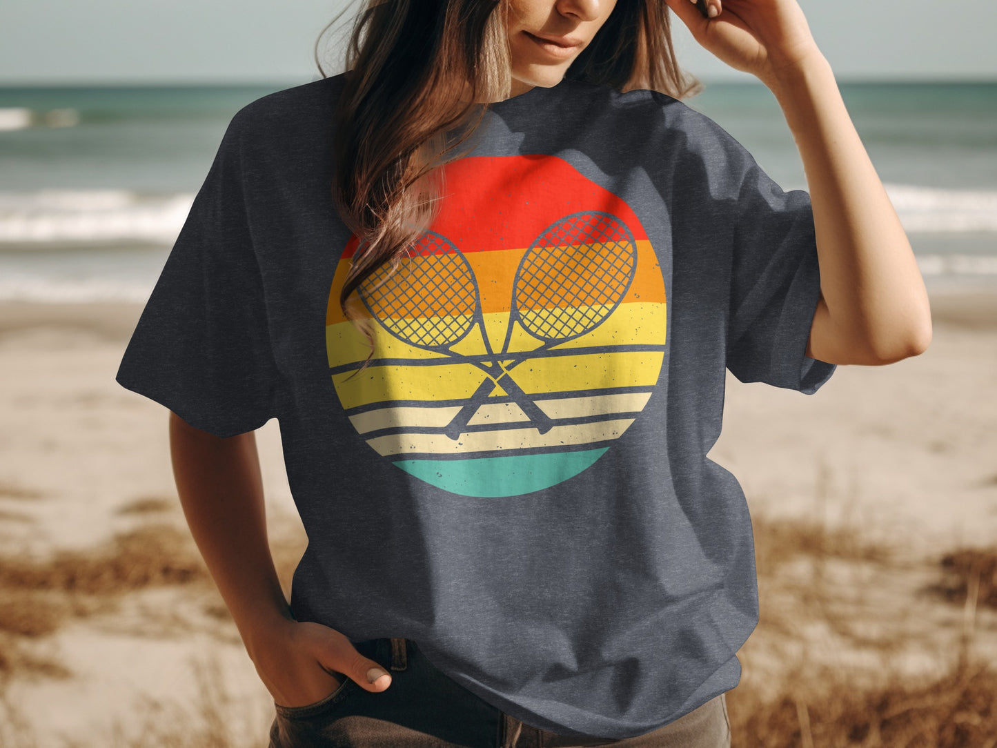 Tennis rackets crossed on a retro sunset graphic on a t-shirt.