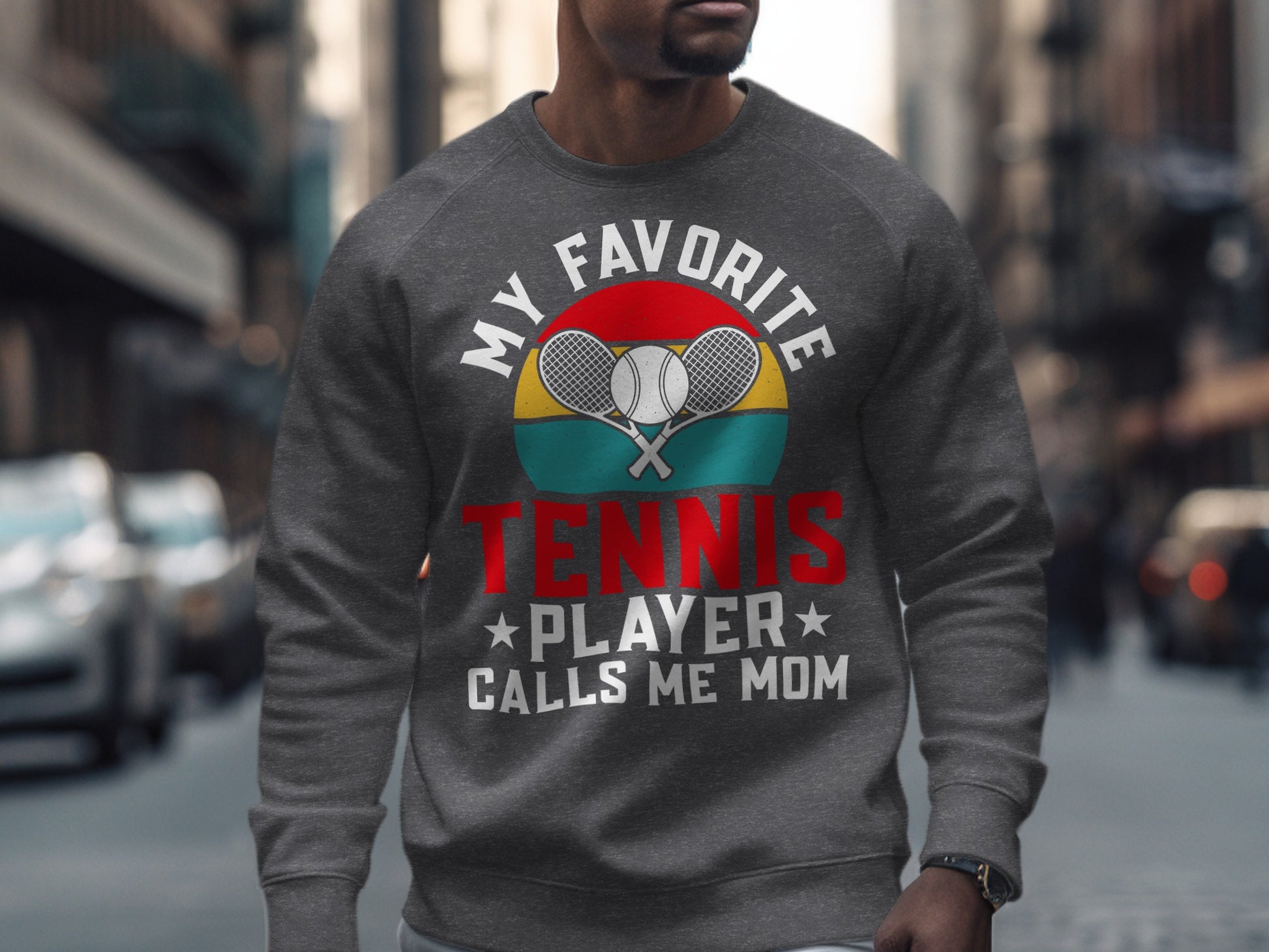 Crewneck sweatshirt with "My Favorite Tennis Player Calls Me Mom" text and crossed racquets.