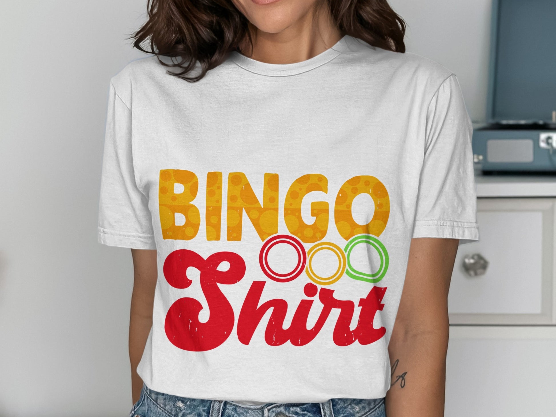 White t-shirt with "BINGO Shirt" text and colorful bingo rings.
