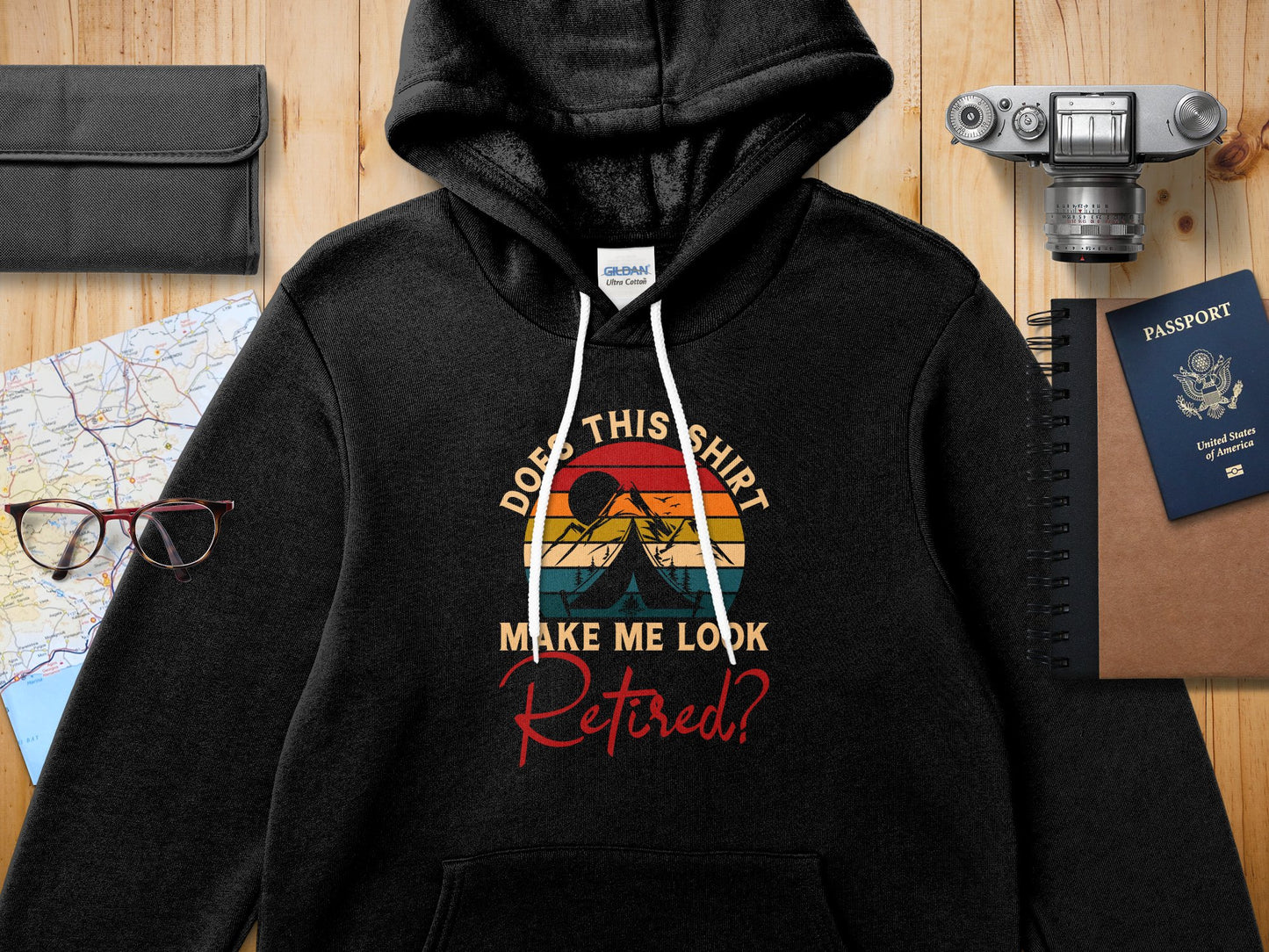 Black Gildan hoodie with "Does this shirt make me look retired?" sunset graphic.