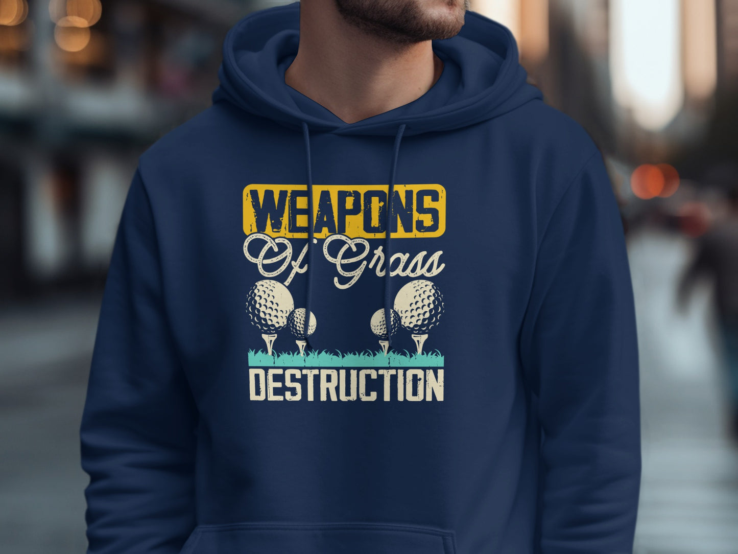 Navy hoodie with "Weapons Of Grass Destruction" text and golf balls.