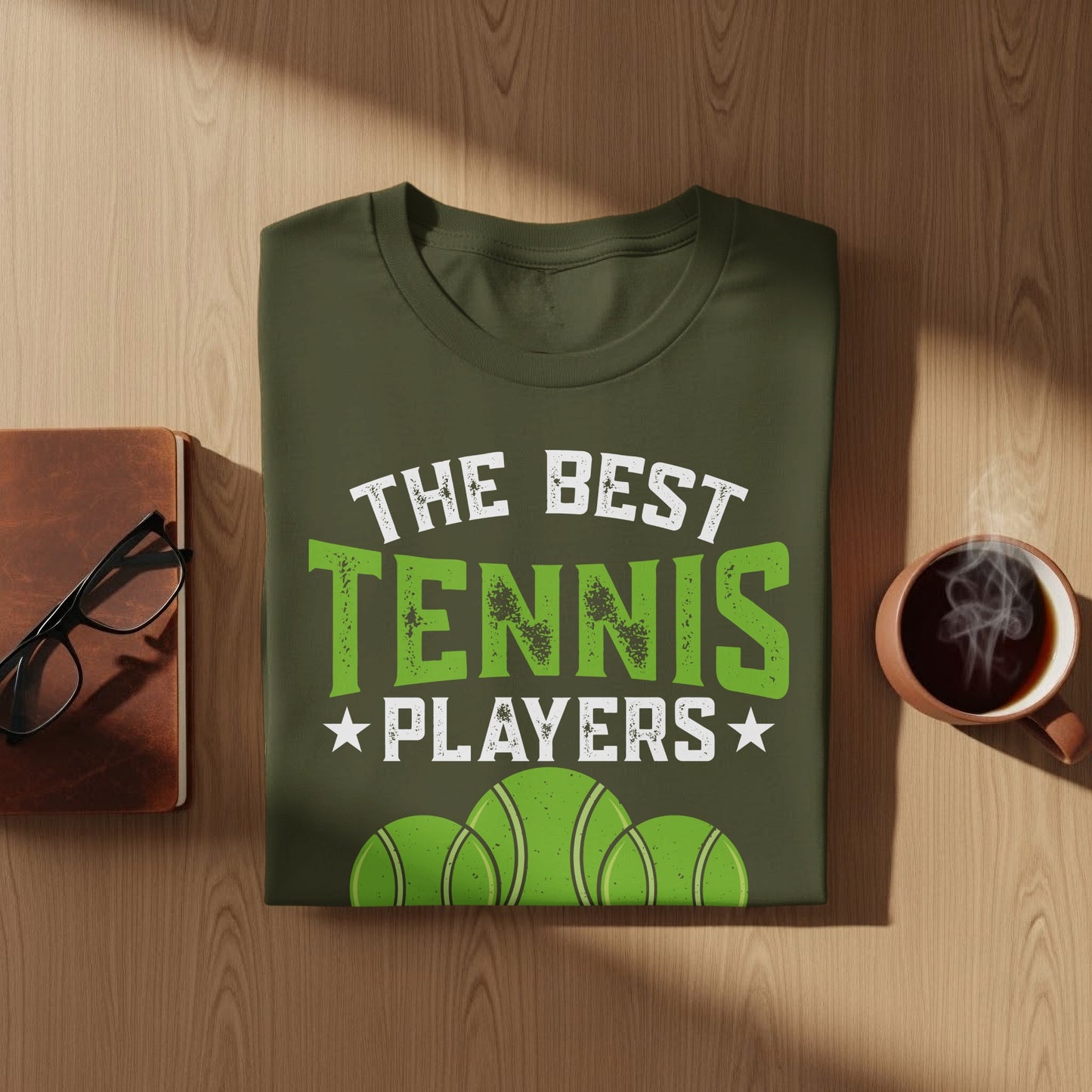 Green t-shirt with "The Best Tennis Players" text and three tennis balls.