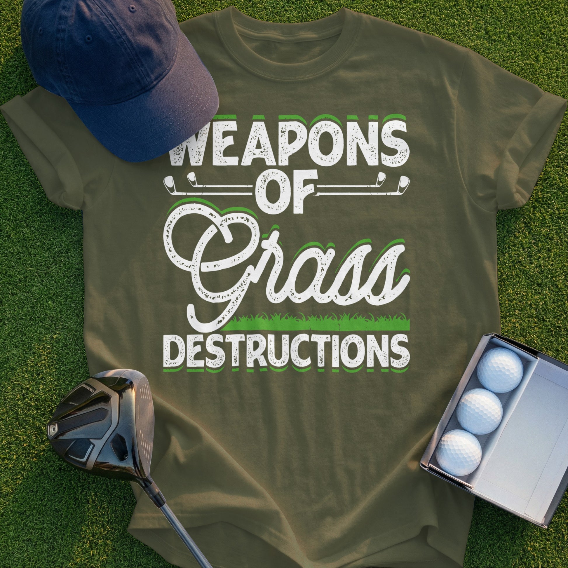 Green t-shirt with "Weapons of Grass Destructions" in white golf-themed text.