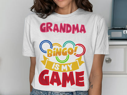 Grandma Bingo is my game text with colorful rings and ribbon graphic on a white t-shirt.