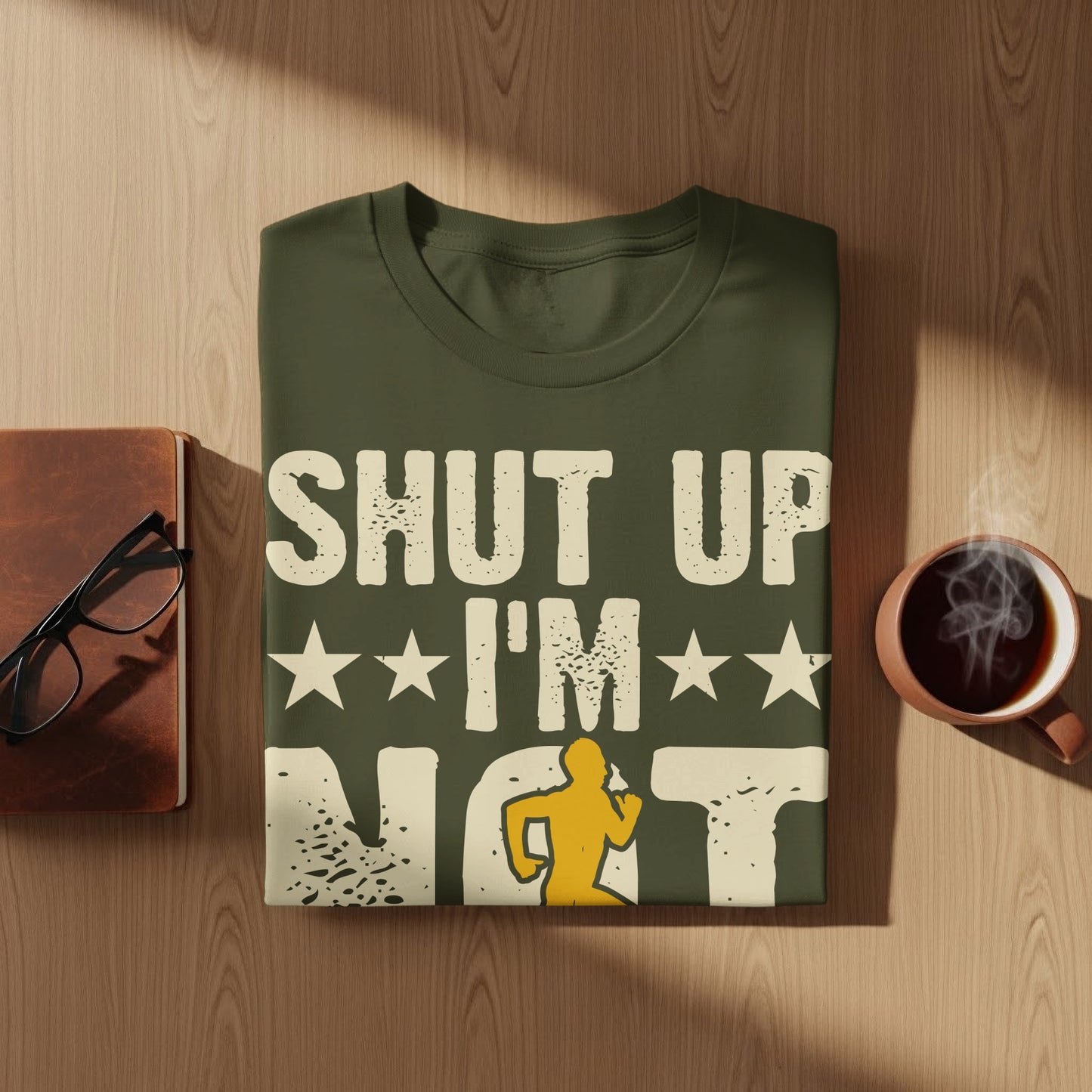 Olive green t-shirt with "SHUT UP I'M NOT" and a running figure graphic.