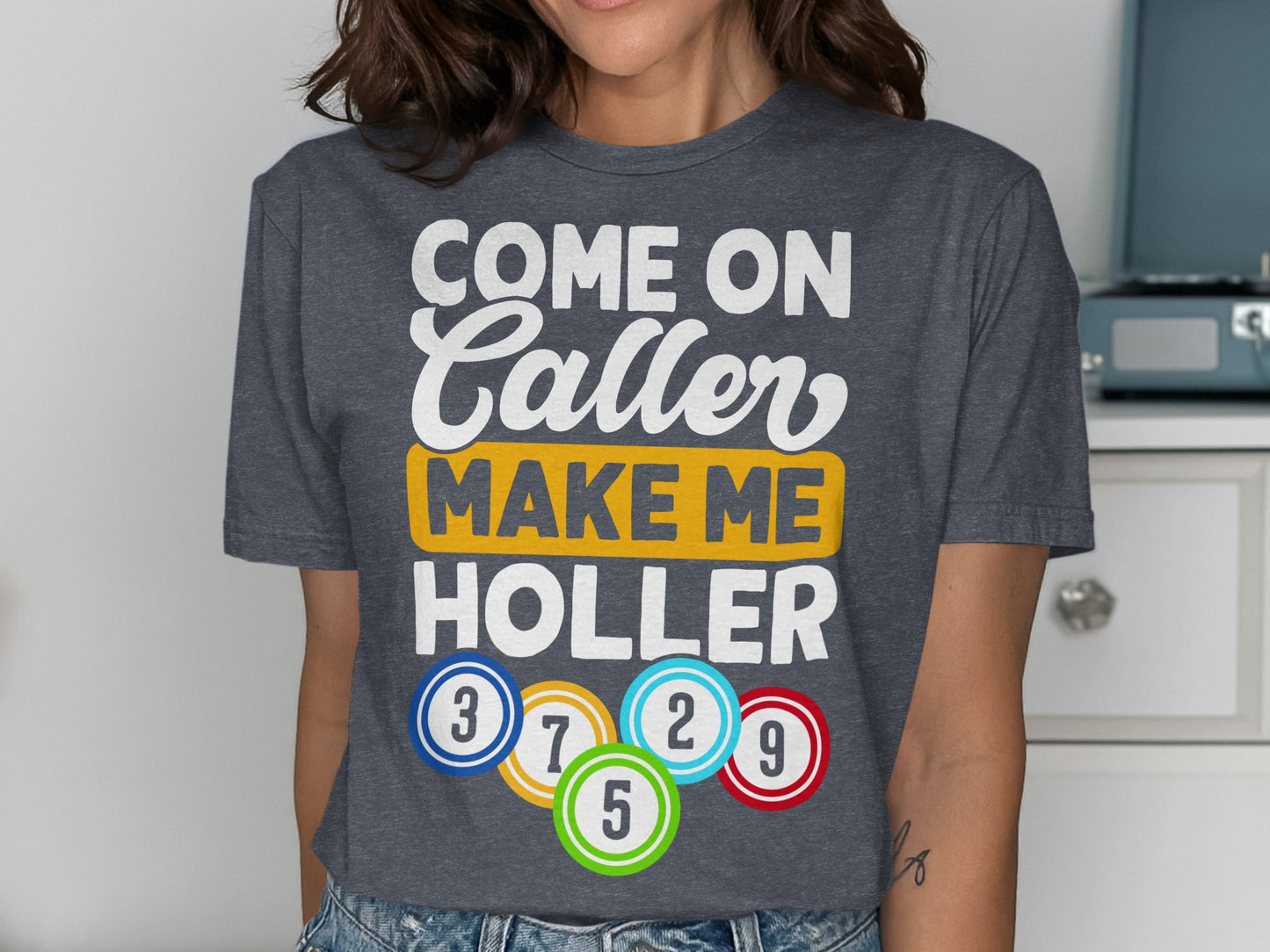 T-shirt with text "Come on Caller Make Me Holler" and bingo balls.