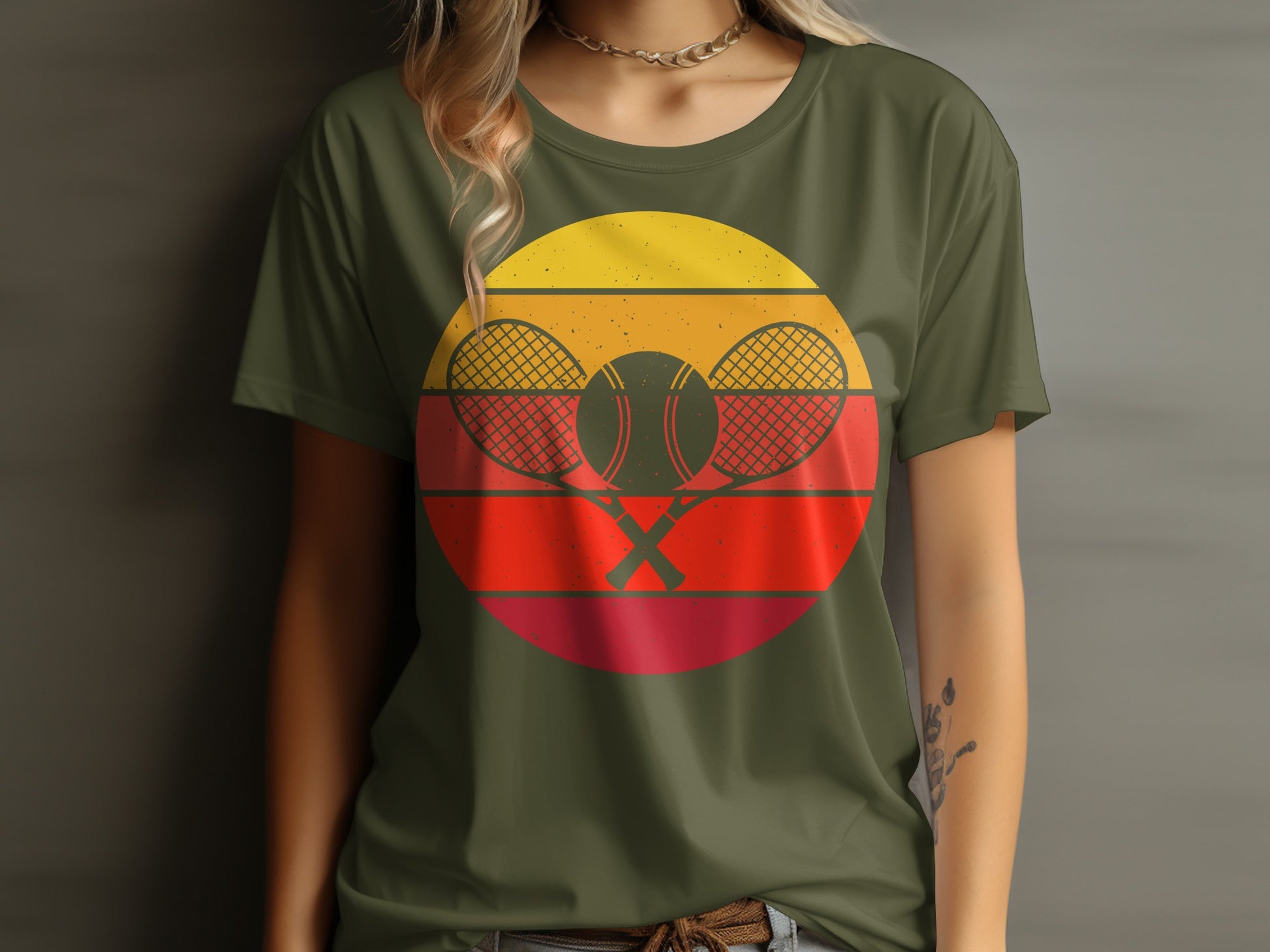 Retro tennis graphic with crossed rackets and balls on a green t-shirt.