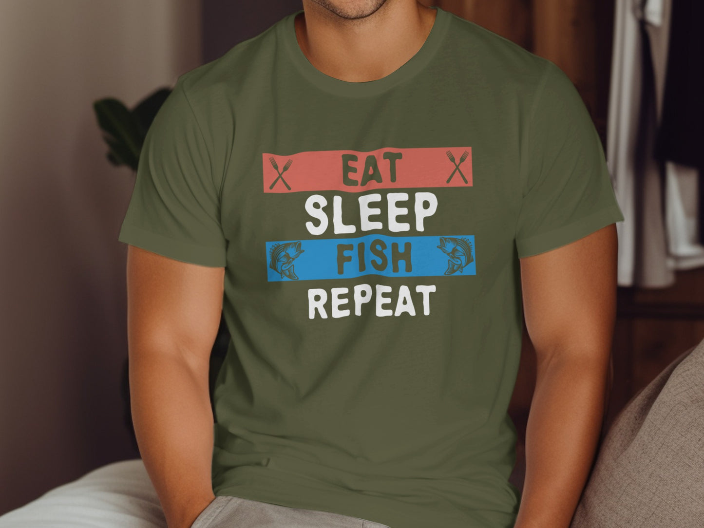 Olive green t-shirt with "Eat Sleep Fish Repeat" text and fish graphics.